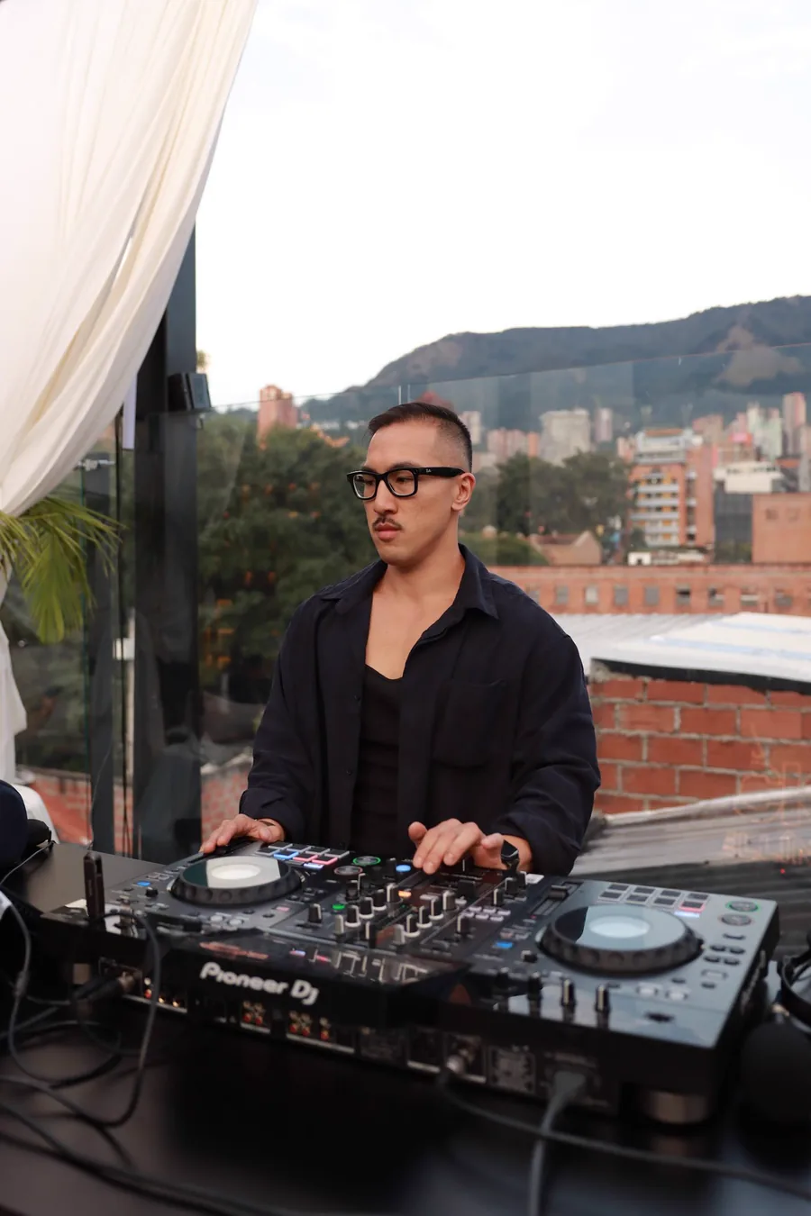 Sean Chi at the decks on a rooftop in Medellín