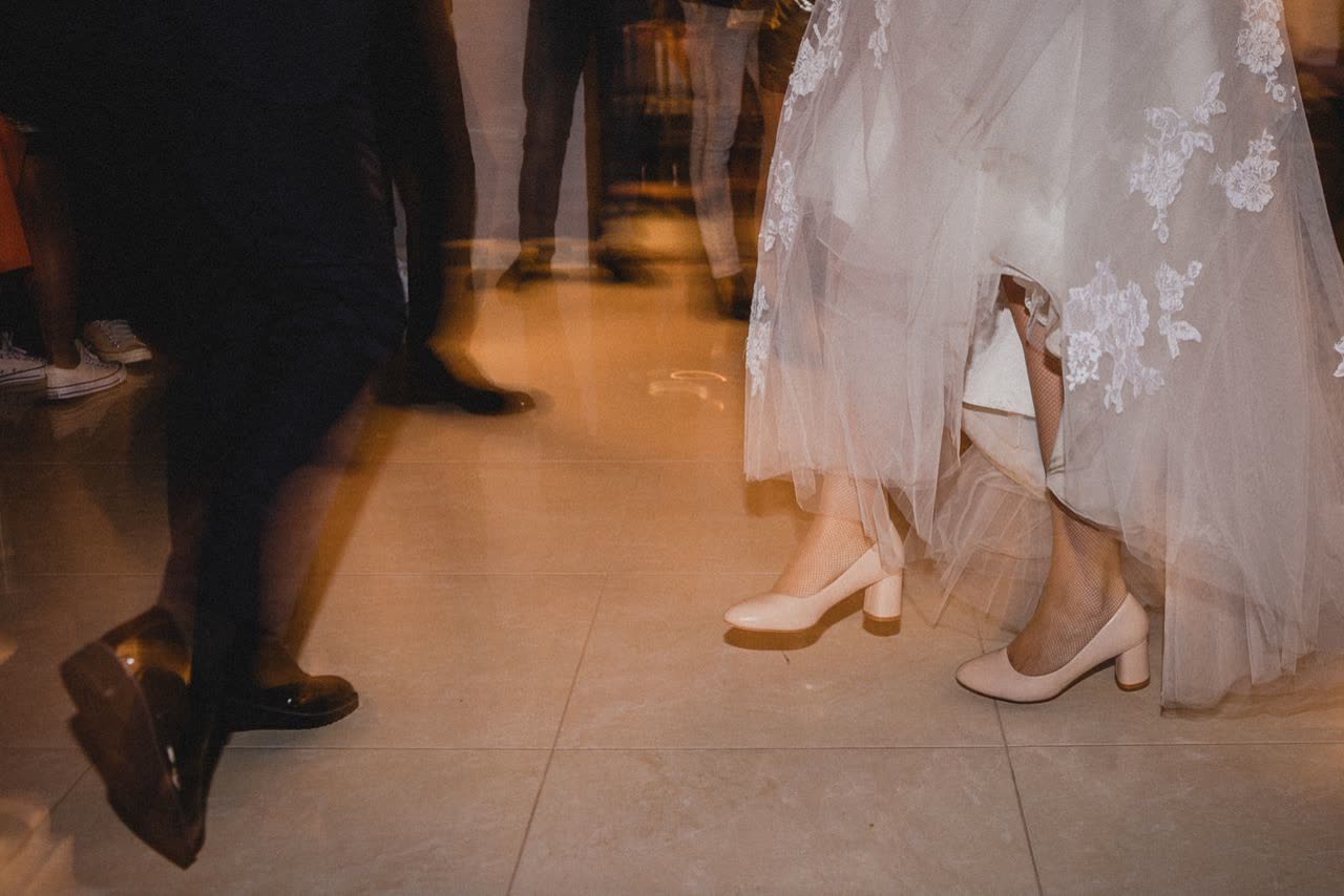 Bride and guest feet on a wedding dancefloor