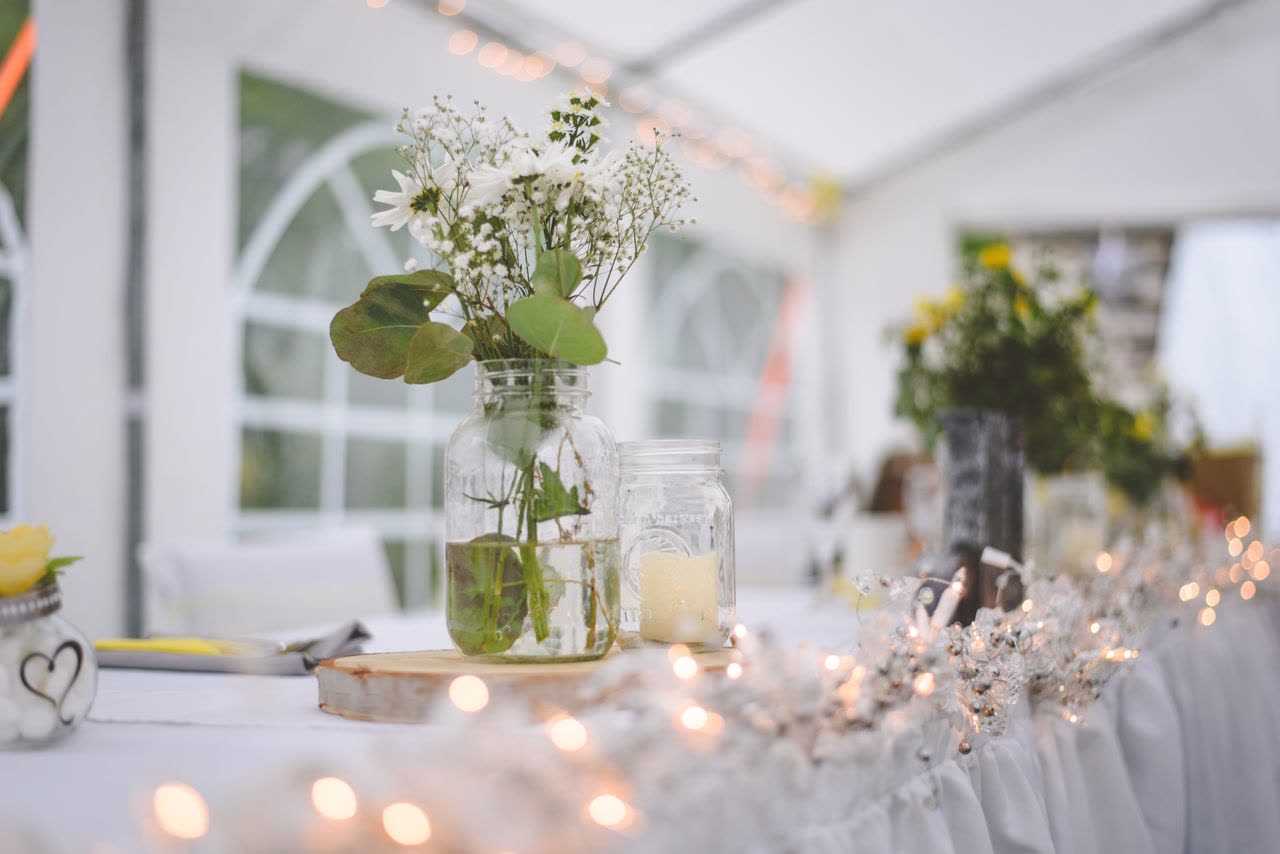 Tent reception tables under string lights